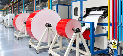 Paper rolls on production line ensuring product consistency