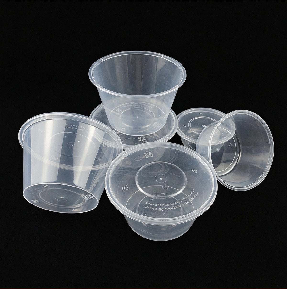 Clear round PP food containers and lids on black background