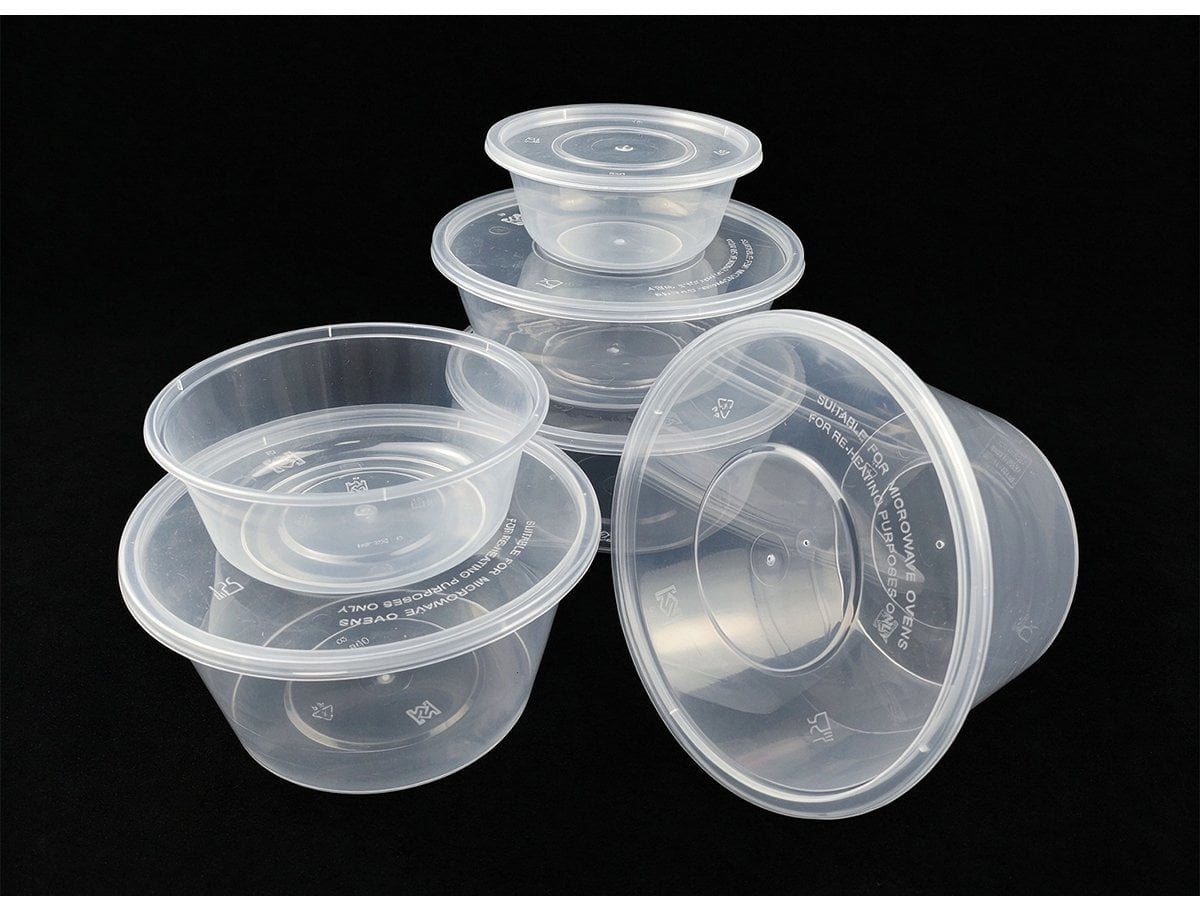 Stacked clear round containers showing microwave reheating lid marking