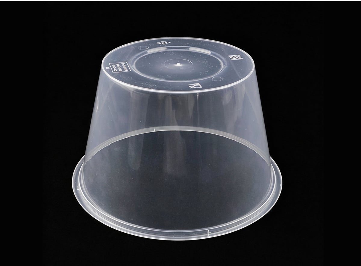 Upside-down clear round PP container showing tapered body