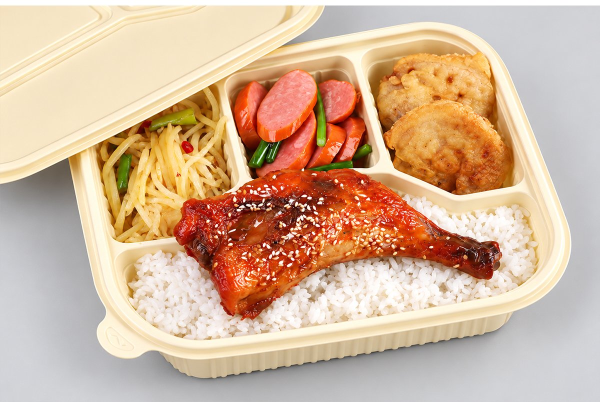 Four-compartment cornstarch meal box with rice, chicken and sides