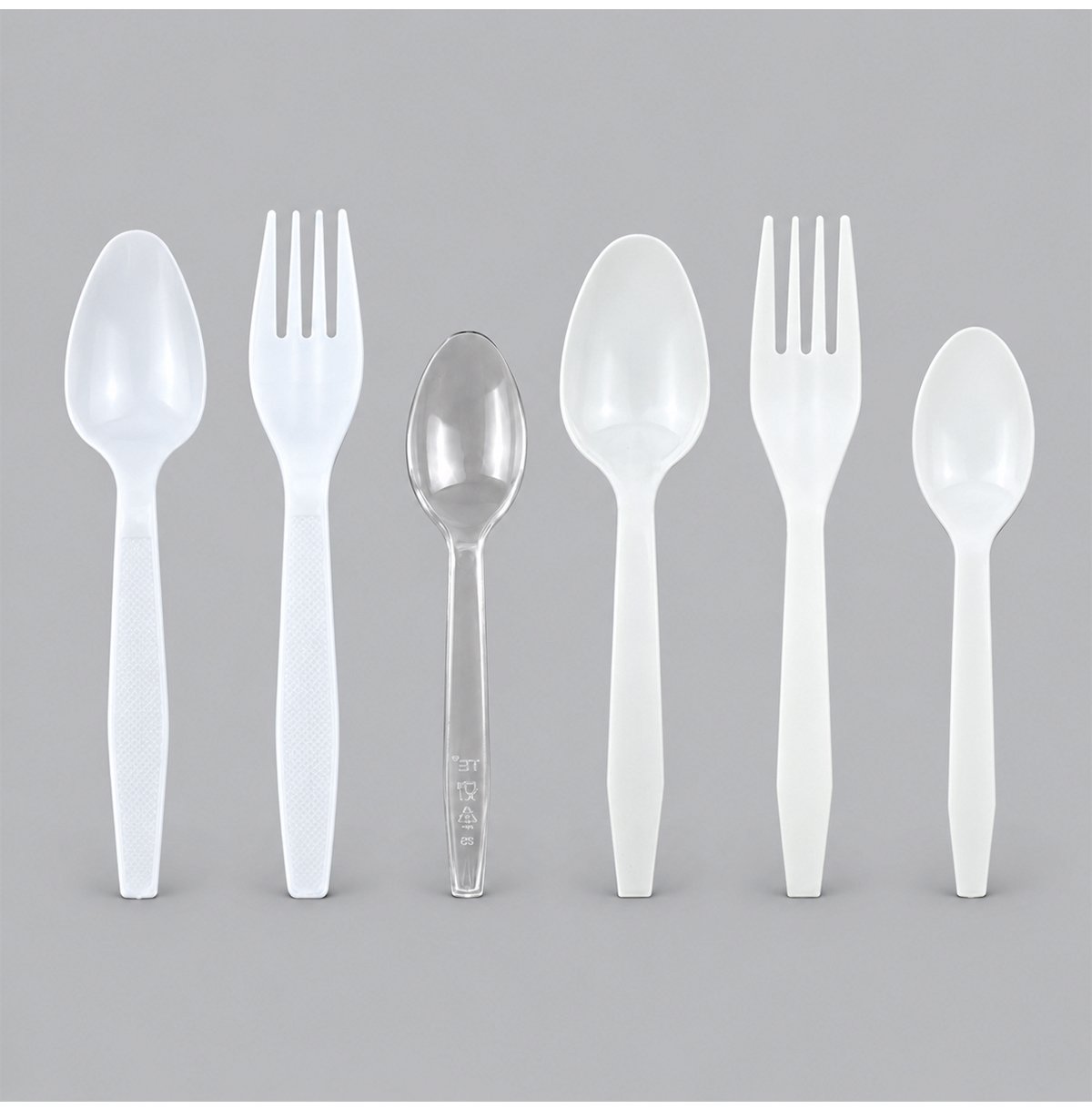 White disposable spoons and forks with a clear teaspoon