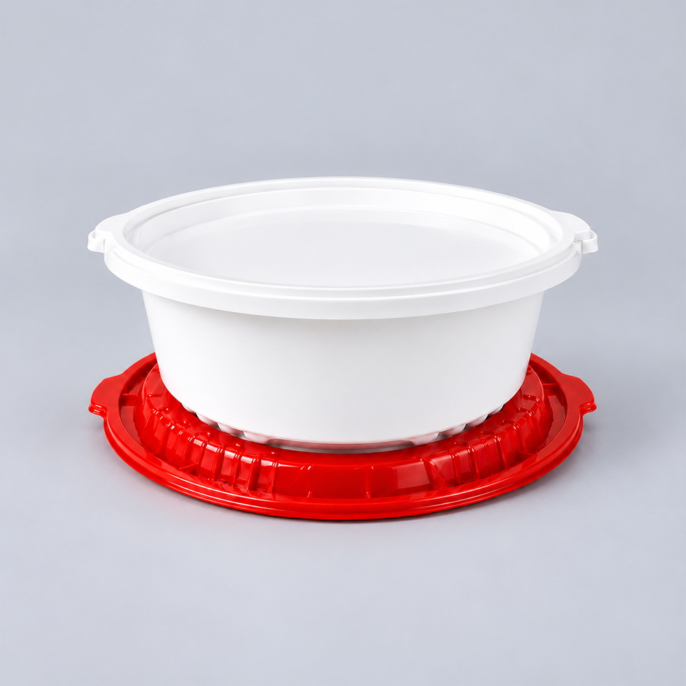 White two-handle round bowl resting on its red lid
